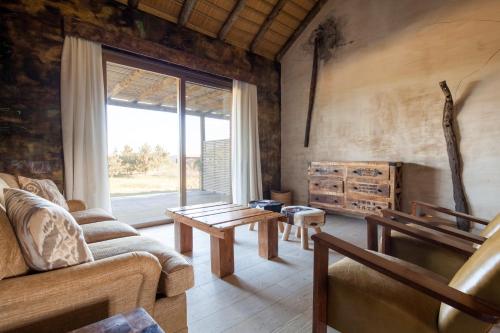 a living room with a couch and a table at Bahia Vik in José Ignacio