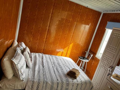 a bedroom with a bed with a wooden wall at Mount Prime Private Suite in Mount Maunganui