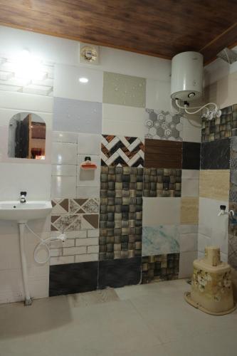 a bathroom with a sink and a mirror at Coorg Backwaters in Suntikoppa
