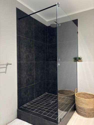 a shower with a glass door in a bathroom at Studio in Woodstock in Cape Town