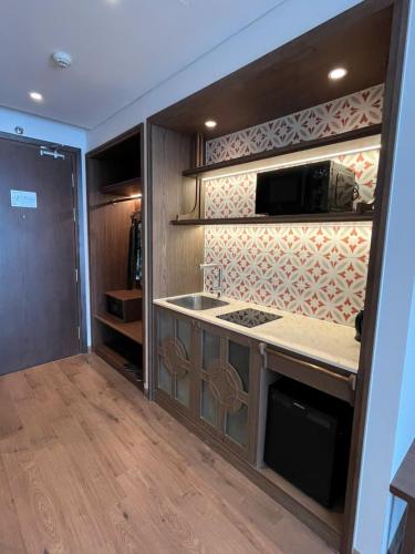 a kitchen with a counter top and a microwave at APEC Mandala Mũi Né VIP in Mui Ne