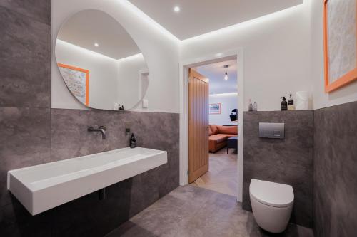 a bathroom with a white sink and a toilet at Old Kirk Apartment in Oban