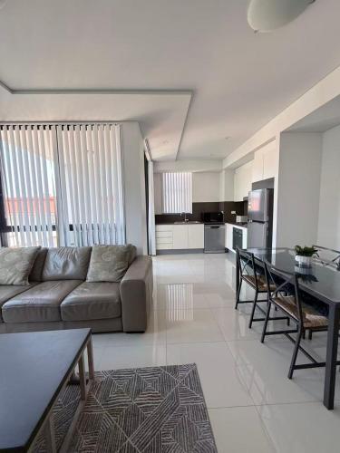 a living room with a couch and a table at The Modern 2B APT Rosebery in Sydney