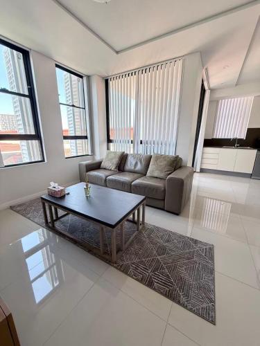 a living room with a couch and a coffee table at The Modern 2B APT Rosebery in Sydney