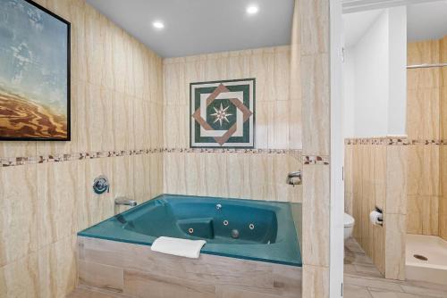 un bagno con vasca in un angolo di Rodeway Inn Commerce - Los Angeles a Commerce