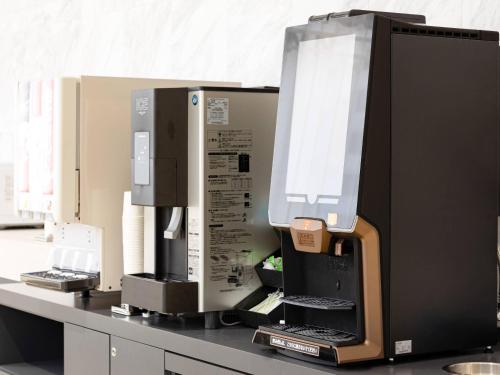 a counter top with a bunch of printers on it at Comfort Inn Nagoya Sakae in Nagoya