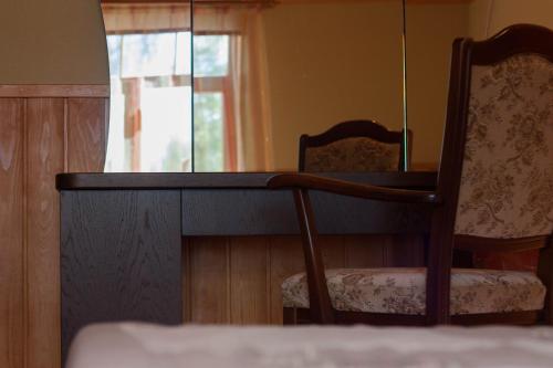 a room with a desk and a chair and a window at Viesu nams Jaunzilakši in Vireši