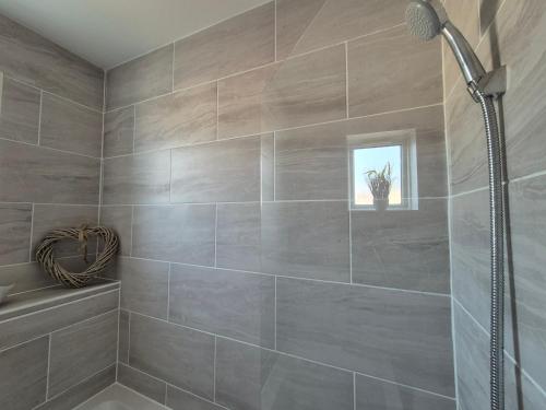 a gray bathroom with a shower and a sink at 2 Bed Maisonette with Sofa Bed - Ideal for Groups #26C in Portsmouth