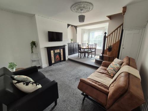 a living room with a couch and a fireplace at 2 Bed Maisonette with Sofa Bed - Ideal for Groups #26C in Portsmouth