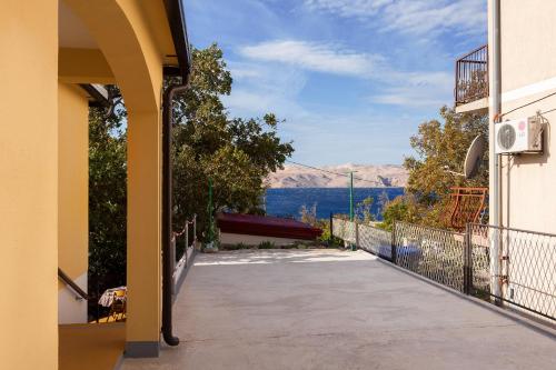 a balcony of a house with a view of the water at Apartman Davorka in Karlobag