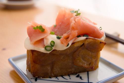 a piece of food on a plate on a table at Country Inn Milky House in Niseko