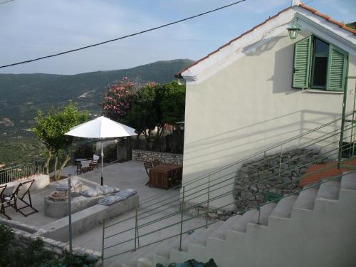 una casa con patio e ombrellone di Nona's house a Vathi