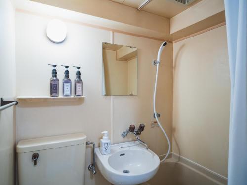 a bathroom with a toilet and a sink at Core royal-vacation rental in Nishinotōindōri