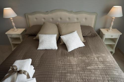 a bed with two white pillows and two night stands at B&B Donna Ada in Salerno