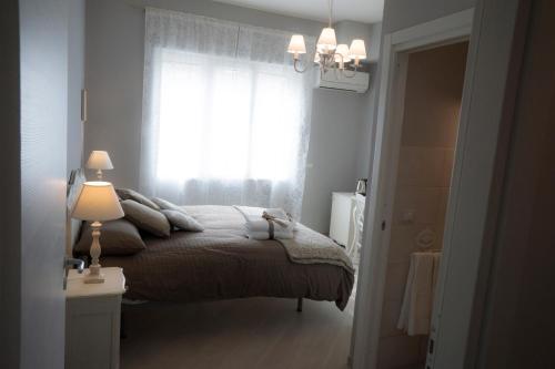 a bedroom with a bed and a window at B&B Donna Ada in Salerno