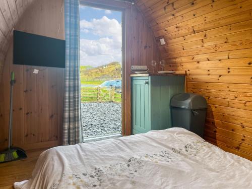 a bedroom with a bed and a large window at Birds - Uk48489 in Dalton in Furness