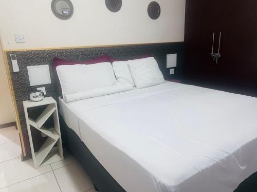 Ένα ή περισσότερα κρεβάτια σε δωμάτιο στο Trojuan Inn Phakalane Suburb, Gaborone