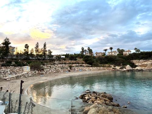 a beach with a pool of water and rocks at Kapparis Beach Escape, near beach, BBQ, free parking in Paralimni