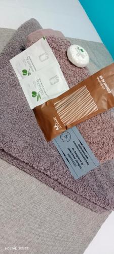 a towel with two tags on top of it at Hostal Urries Restaurante in Urriés