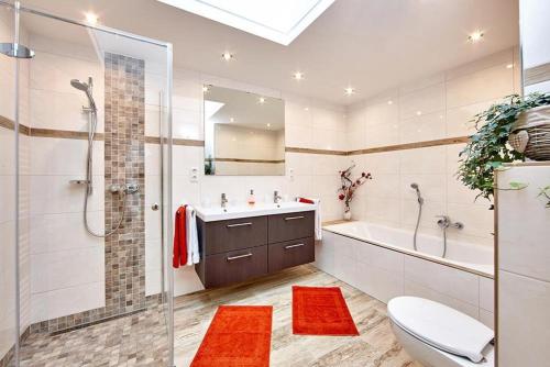 a bathroom with a shower and a toilet and a sink at Landhaus Bergliebe in Mittenwald
