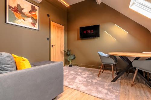 a living room with a couch and a table at High Street Hideaway, private entrance, parking in Bristol
