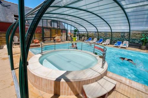 a large swimming pool with a large swimming poolvisor at ZEcamping 4 avec pet friendly piscine couverte à 200m de la plage in Plomodiern
