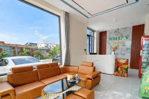 ein Wohnzimmer mit Couch und großem Fenster in der Unterkunft Như Ý Hotel Tây Ninh in Tây Ninh