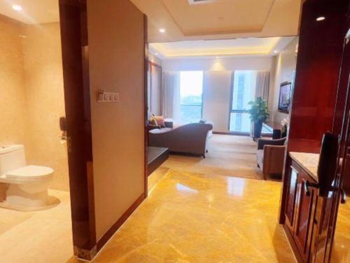 厦门Peony Harbor City Hotel的带沙发和卫生间的客厅
