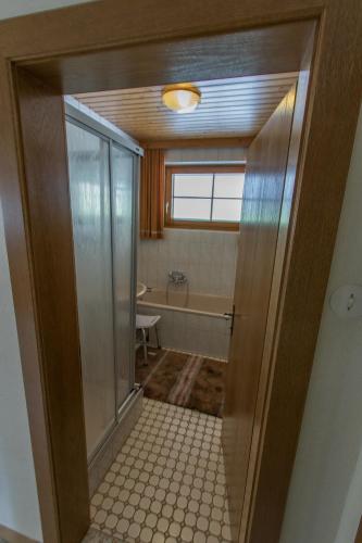 a bathroom with a walk in shower and a tub at Gästehaus Struggl in Steindorf am Ossiacher See