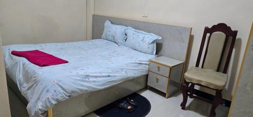 una piccola camera da letto con un letto e una sedia di Temesegen Hotel ad Axum