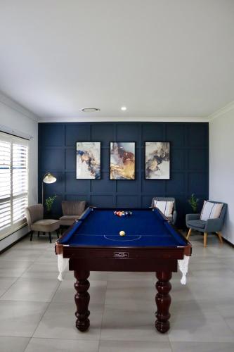 a pool table in a living room with blue walls at Two Williams Estate - Hunter Valley in Cessnock