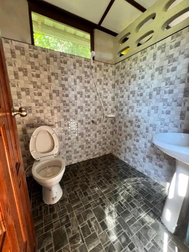 a bathroom with a toilet and a sink at Tiger home stay Phayam in Ko Phayam