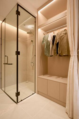 a walkin closet with a glass shower backdoor at HAITA Suites - Phu My Hung in Ho Chi Minh City