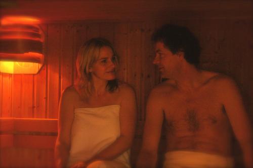 a man and a woman sitting next to each other at De Stobbe hotel & suites in Ruinen