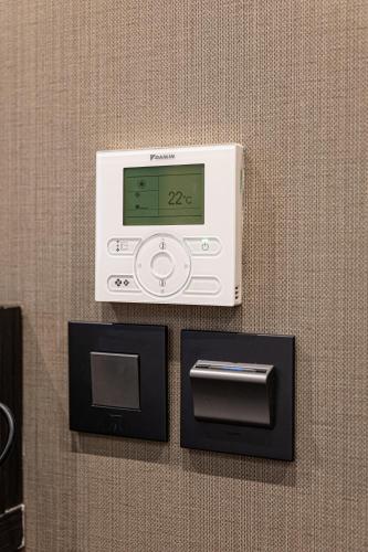 a digital clock on a wall with a box at The House of Toby in London