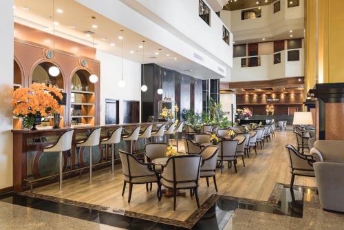 a restaurant with a row of chairs and tables at Royal Phuket City Hotel in Phuket