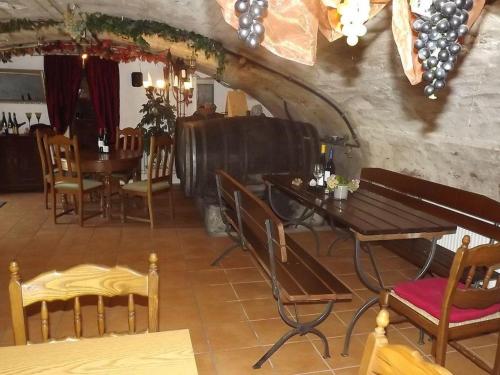 a restaurant with tables and chairs in a room at Ferienwohnungen Schneider-Kettern in Neumagen-Dhron
