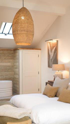 a bedroom with a large white bed and a window at The Drama Studio in Moreton in Marsh