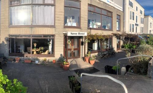 a shop with a sign on the front of a building at Savoy Hotel in Weston-super-Mare
