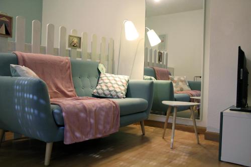 a living room with two chairs and a tv at La Colombière - Montélimar in Montélimar