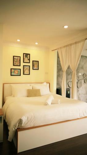 a bedroom with a large white bed with a window at Hanoi Brilliant Home in Hanoi