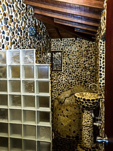 a bathroom with a bunch of glass tiles on the wall at The Secret Buddha in Medellín