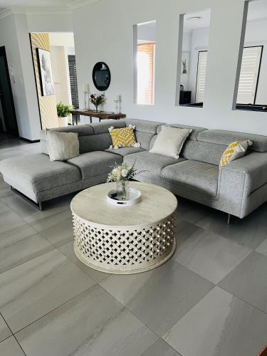 a living room with a couch and a coffee table at Two Williams Estate - Hunter Valley in Cessnock