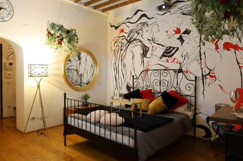 a room with a crib and a wall with a mural at Lunar artistic loft in Pisa