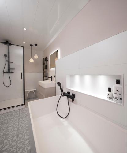 a white bathroom with a shower and a sink at Villa Orange Tree in Bernkastel-Kues