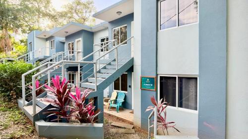 een blauw-wit gebouw met trappen en planten bij Sunny dream in Sandy Bay