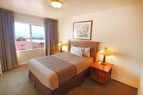 a hotel room with a bed and a window at Capitola Venetian Vacation Rentals in Capitola