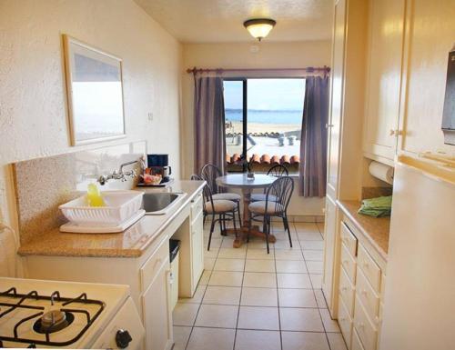 a kitchen with a sink and a table with a view at Capitola Venetian Vacation Rentals in Capitola
