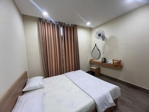 En eller flere senge i et værelse på T Homestay