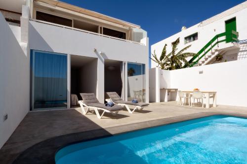 a villa with a swimming pool and a patio at Villa Sunrise Private Pool Puerto del Carmen By PVL in Puerto del Carmen